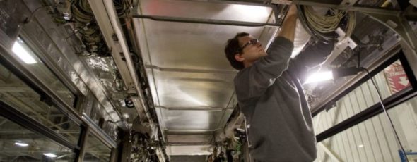 Piotr Job, right, and Sabino Iacobucci work on a Toronto streetcar National Post | James Alexander Michie