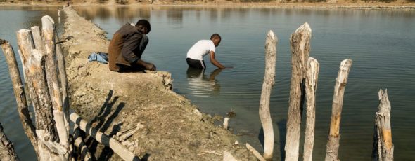 Grad student Karim Mtili (right) collects gas samples in Itumbula, Tanzania Bloomberg | James Alexander Michie