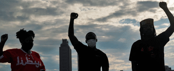 People raise their fists in Atlanta National Post | James Alexander Michie