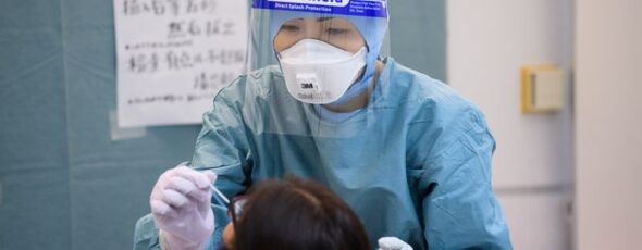 A medical worker Airport Japan Bloomberg | James Alexander Michie