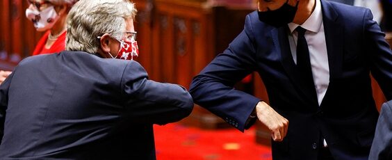 Prime Minister Justin Trudeau greets a Senator with an elbow-bump National Post | James Alexander Michie